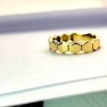 Създаден от изящно злато и украсен с бели камъни с геометрични елементи .Модерен дизайн.Удобен за всеки ден и всеки повод.