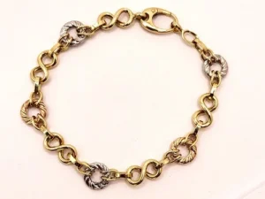 бутикова изискана мека  златна гривна от 14 к трицветно злато с акцент златни рингове с геометрична шарка и звена тип знак за безкрайност за акцент и блясък